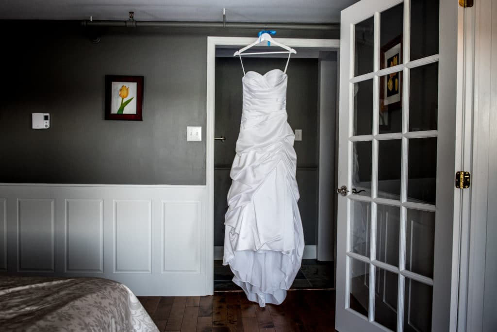wedding dress hanging in hotel room