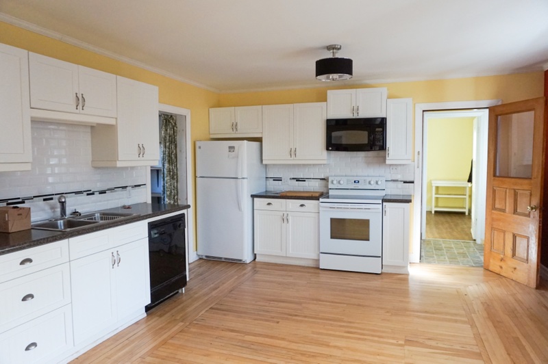 Yellow kitchen with white cupboards