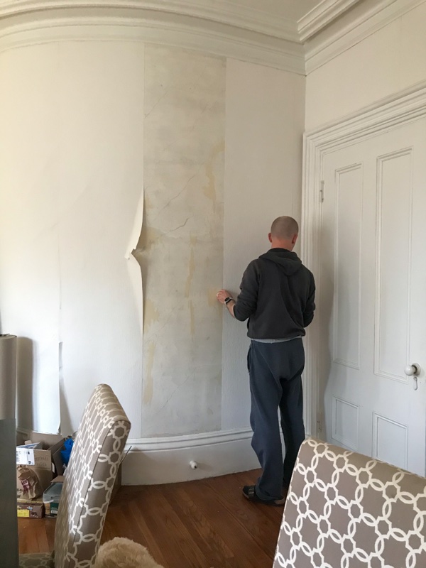 Removing wallpaper from a white room